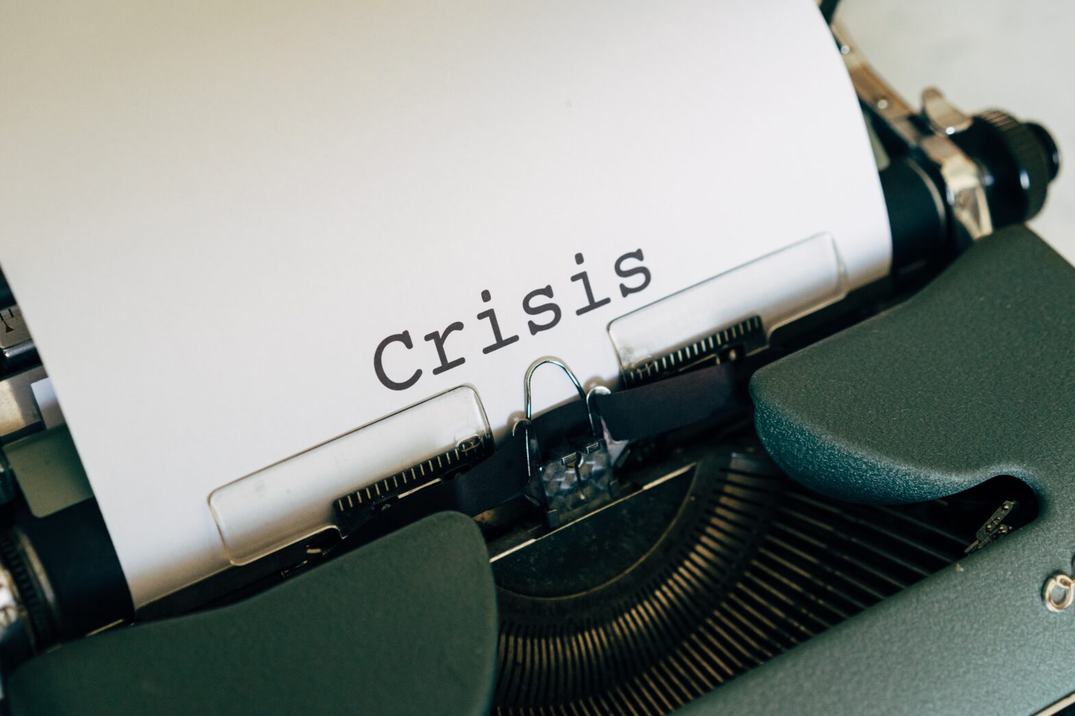 typewriter with the word "Crisis"